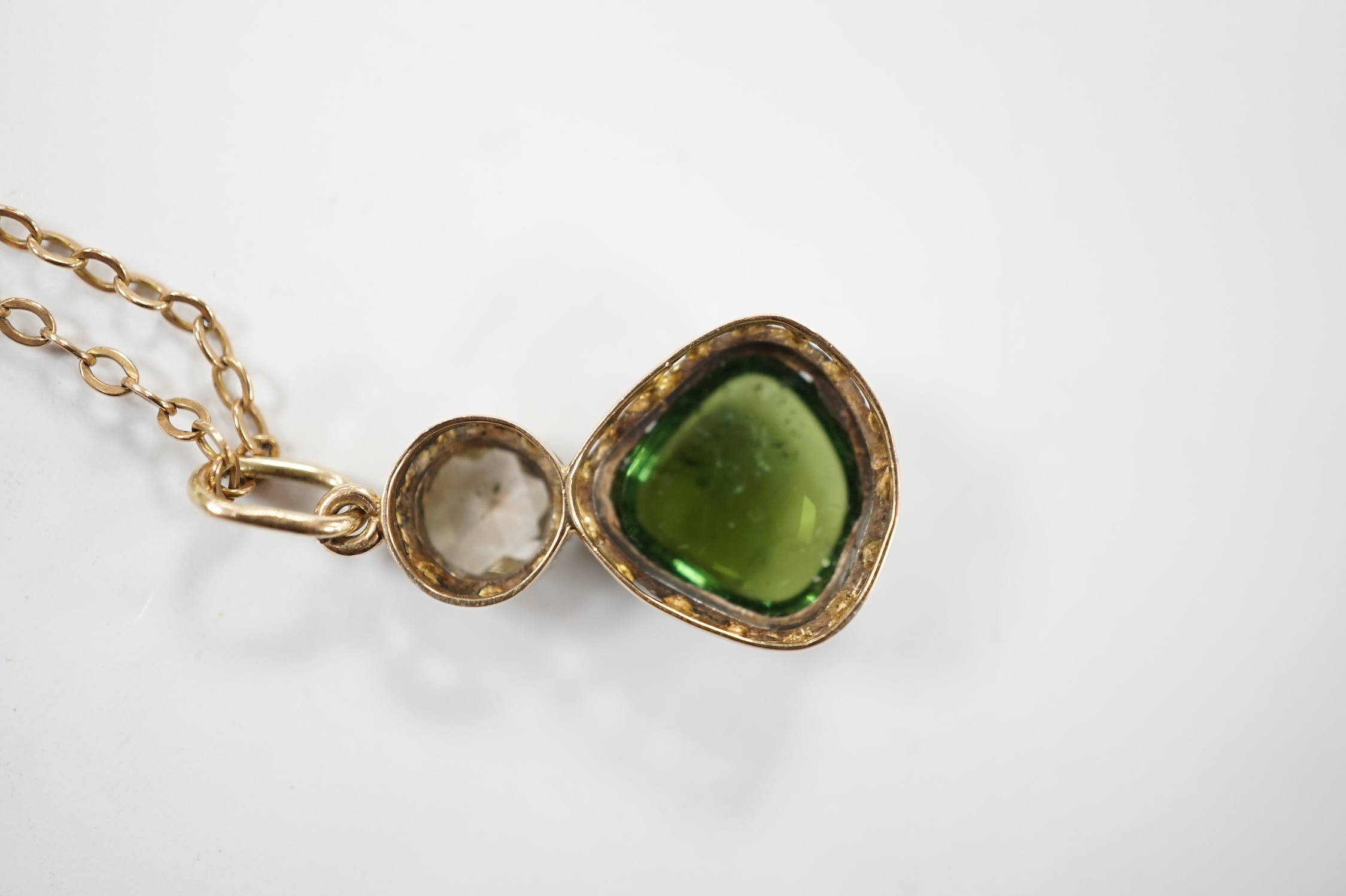 A Georgian yellow and white metal, rose cut diamond and shaped cabochon green tourmaline set pendant, 24mm, on a yellow metal chain, 48cm, gross weight 5.8 grams. Fair condition.
